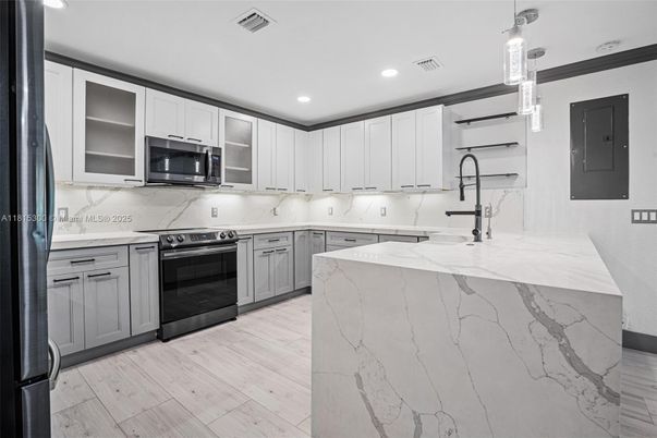 Interior, Kitchen, Marble Walls, Pendant Lights, Recessed Lighting, Stainless Steel Appliances, Wood Texture Flooring