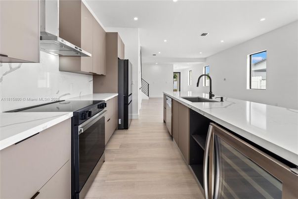 Interior, Kitchen, Marble Walls, Recessed Lighting, Stainless Steel Appliances, Wood Texture Flooring