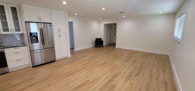Empty room, Interior, Kitchen, Recessed Lighting, Stainless Steel Appliances, Wood Texture Flooring