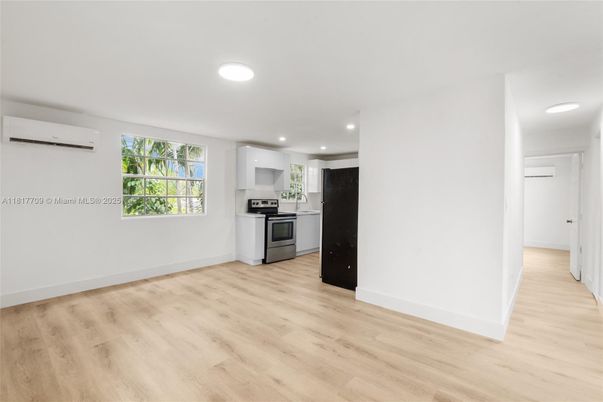 Empty room, Interior, Kitchen, Recessed Lighting, Stainless Steel Appliances, Wood Texture Flooring