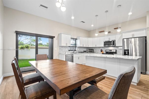 Dining room, Interior, Kitchen, Pendant Lights, Recessed Lighting, Stainless Steel Appliances, Wood Texture Flooring