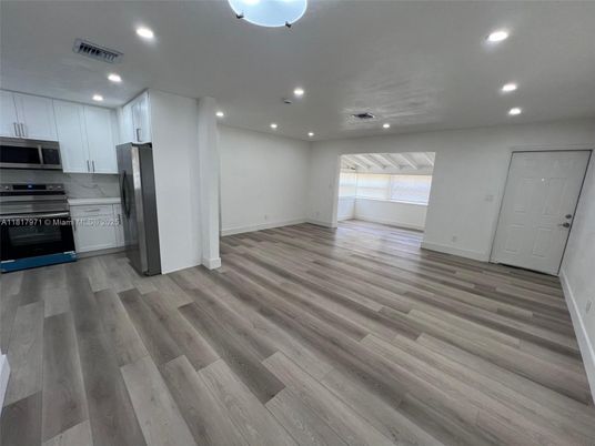Empty room, Interior, Kitchen, Recessed Lighting, Stainless Steel Appliances, Wood Texture Flooring