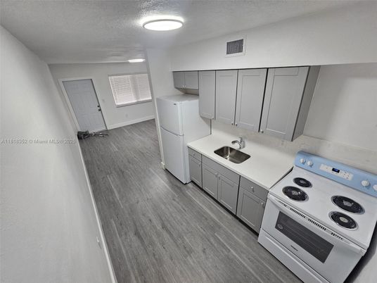 Interior, Kitchen, Recessed Lighting, Washer, Wood Texture Flooring