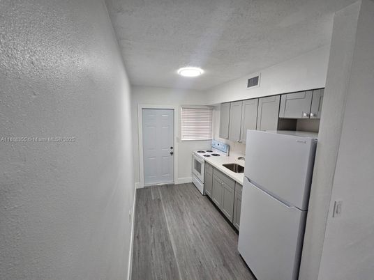 Interior, Kitchen, Recessed Lighting, Washer, Wood Texture Flooring
