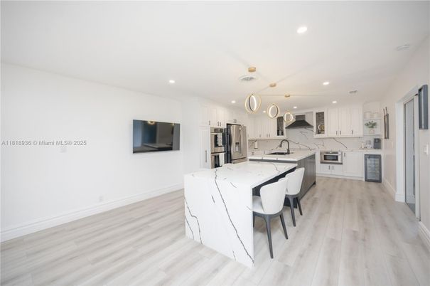 Dining room, Interior, Kitchen, Marble Walls, Recessed Lighting, Stainless Steel Appliances, Wood Texture Flooring