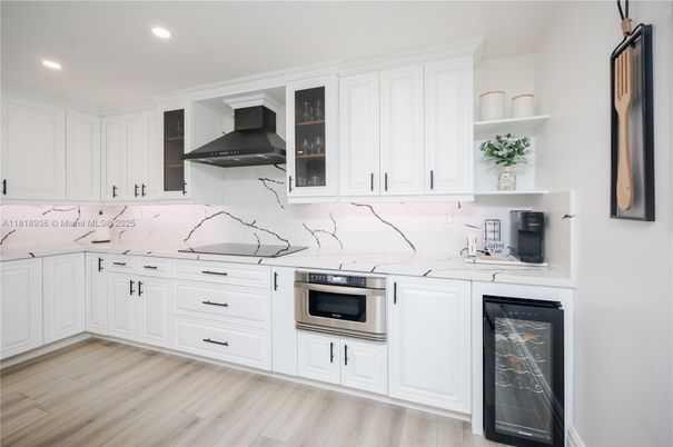 Interior, Kitchen, Marble Walls, Recessed Lighting, Stainless Steel Appliances, Wood Texture Flooring
