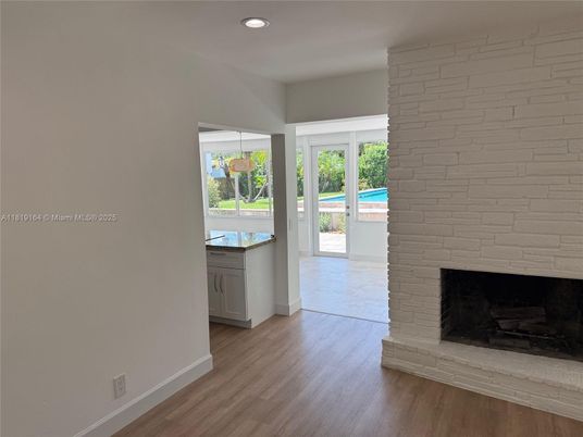 Empty room, Fireplace, Interior, Recessed Lighting, Stone Walls, Wood Texture Flooring