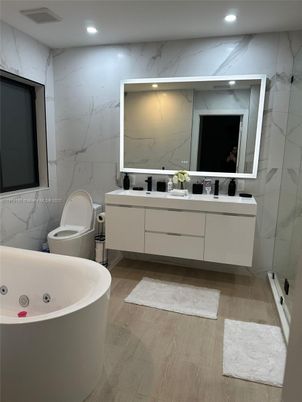 Bathroom, Dual Sink Vanities, Free Standing Baths, Interior, Marble Walls, Recessed Lighting, Wood Texture Flooring
