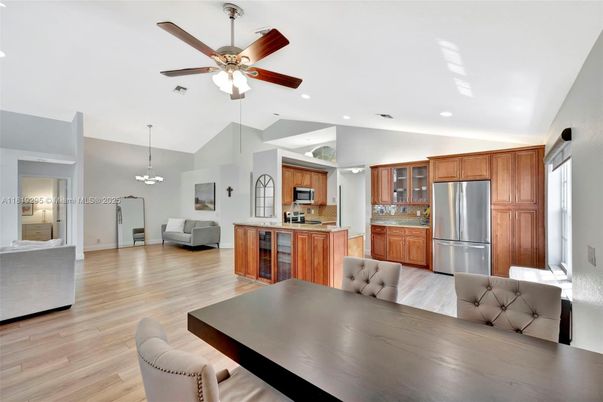 Chandelier, Dining room, Interior, Kitchen, Living room, Pendant Lights, Recessed Lighting, Stainless Steel Appliances, Wood Texture Flooring