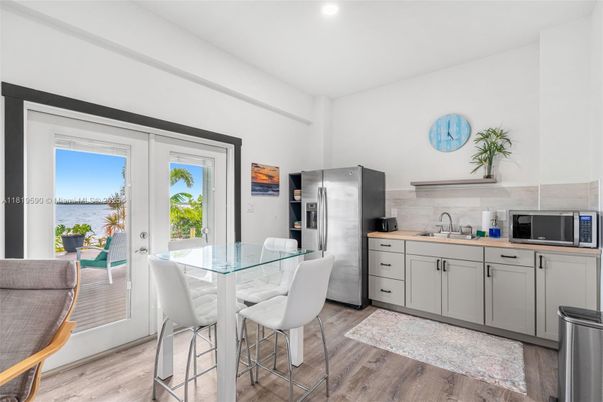 Dining room, Interior, Kitchen, Recessed Lighting, Stainless Steel Appliances, Water, Wood Texture Flooring
