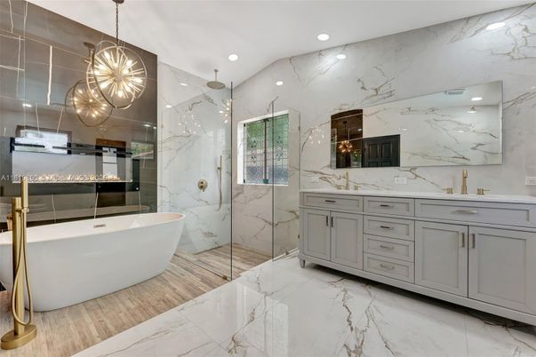 Bathroom, Dual Sink Vanities, Free Standing Baths, Glass Shower, Interior, Marble, Marble Walls, Pendant Lights, Recessed Lighting, Wood Texture Flooring