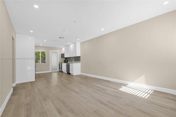 Empty room, Interior, Kitchen, Recessed Lighting, Stainless Steel Appliances, Wood Texture Flooring