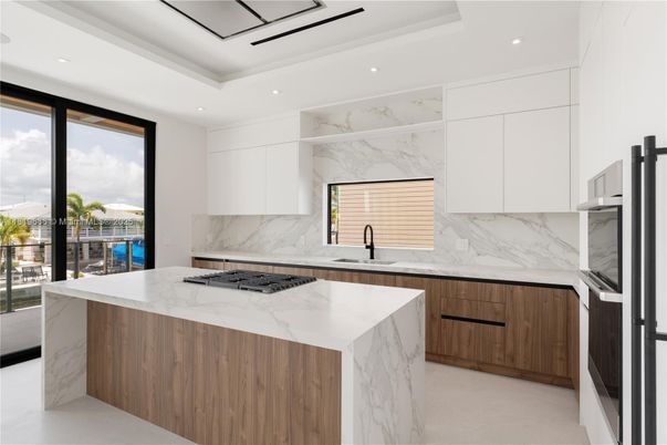 Interior, Kitchen, Marble Walls, Recessed Lighting, Stainless Steel Appliances