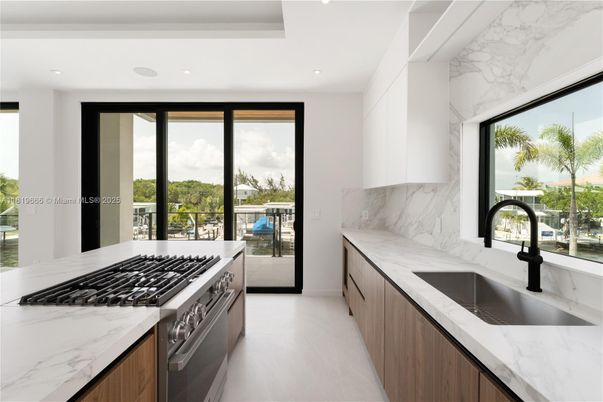 Interior, Kitchen, Marble Walls, Recessed Lighting, Stainless Steel Appliances, Water