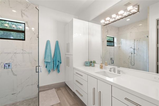Bathroom, Dual Sink Vanities, Glass Shower, Interior, Marble Walls, Wood Texture Flooring
