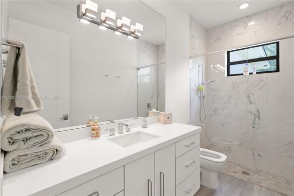 Bathroom, Glass Shower, Interior, Marble Walls, Recessed Lighting, Wood Texture Flooring