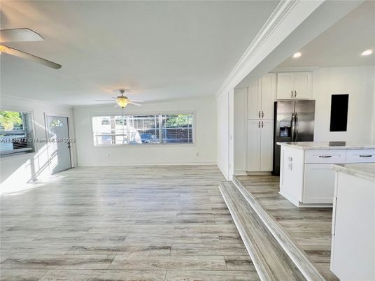Empty room, Interior, Kitchen, Recessed Lighting, Stainless Steel Appliances, Wood Texture Flooring