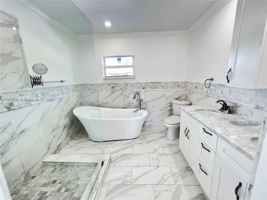 Bathroom, Dual Sink Vanities, Free Standing Baths, Glass Shower, Interior, Marble, Marble Walls, Recessed Lighting