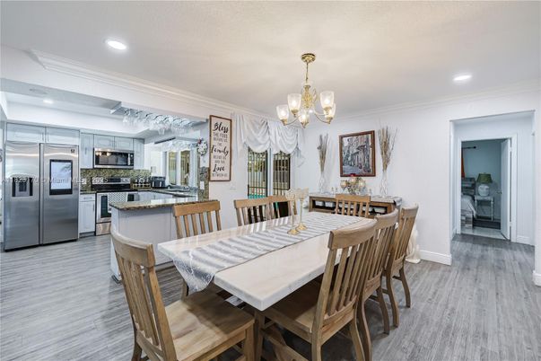 Chandelier, Dining room, Interior, Kitchen, Recessed Lighting, Stainless Steel Appliances, Wood Texture Flooring