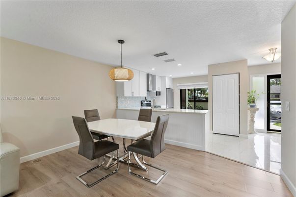 Dining room, Interior, Kitchen, Pendant Lights, Recessed Lighting, Stainless Steel Appliances, Wood Texture Flooring