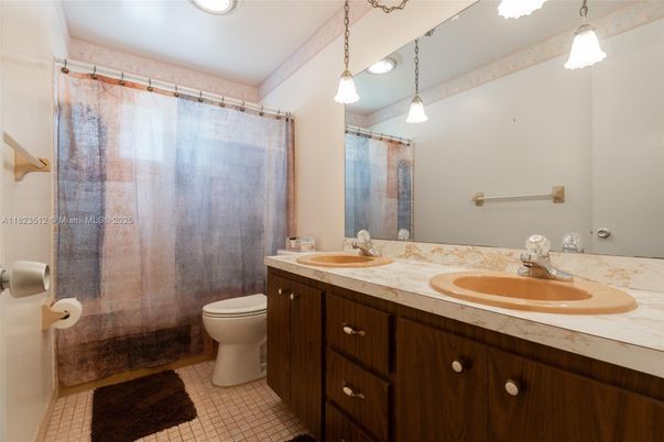 Bathroom, Dual Sink Vanities, Interior, Pendant Lights, Recessed Lighting, Tile Countertops