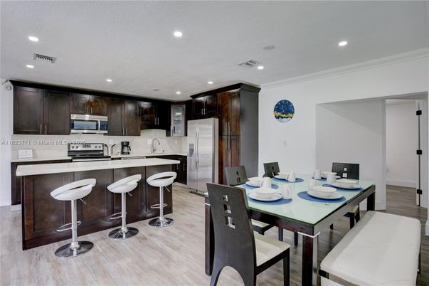 Dining room, Interior, Kitchen, Recessed Lighting, Stainless Steel Appliances, Wood Texture Flooring