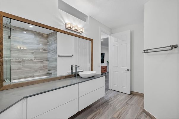 Bathroom, Dual Sink Vanities, Glass Shower, Interior, Recessed Lighting, Wood Texture Flooring
