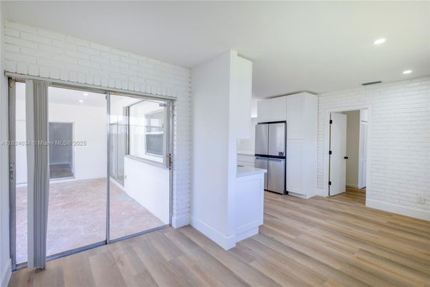 Empty room, Interior, Kitchen, Recessed Lighting, Stone Walls, Utility Closets, Washer, Wood Texture Flooring