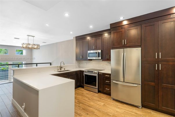 Chandelier, Interior, Kitchen, Pendant Lights, Recessed Lighting, Stainless Steel Appliances, Wood Texture Flooring