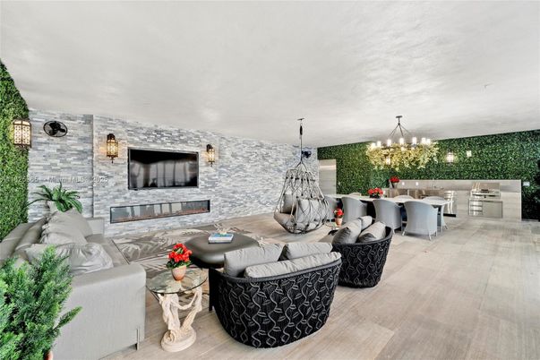 Chandelier, Dining room, Fireplace, Interior, Kitchen, Living room, Pendant Lights, Stainless Steel Appliances, Stone Walls, Wood Texture Flooring
