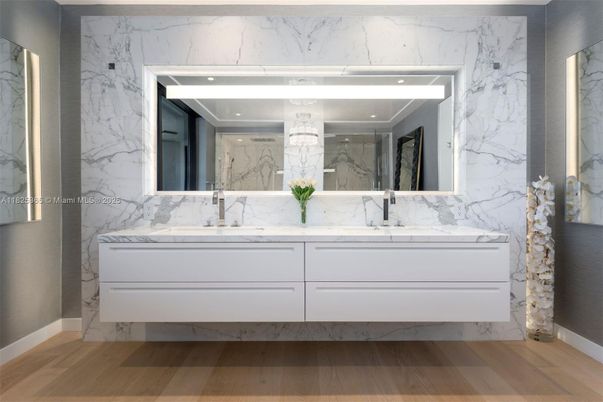 Bathroom, Dual Sink Vanities, Interior, Marble Walls, Recessed Lighting, Wood Texture Flooring