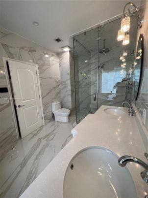 Bathroom, Dual Sink Vanities, Glass Shower, Interior, Marble, Marble Walls, Recessed Lighting