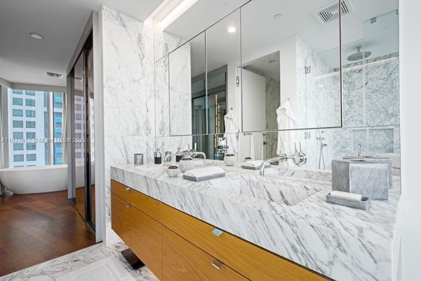 Bathroom, Dual Sink Vanities, Glass Shower, Interior, Marble, Marble Walls, Recessed Lighting, Wood Texture Flooring