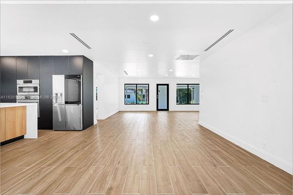 Empty room, Interior, Kitchen, Recessed Lighting, Stainless Steel Appliances, Wood Texture Flooring