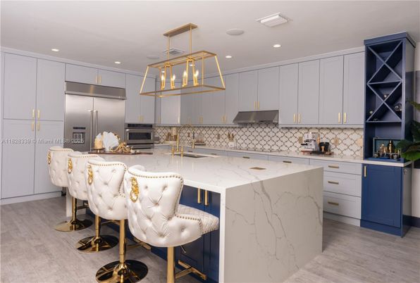 Interior, Kitchen, Marble Walls, Pendant Lights, Recessed Lighting, Stainless Steel Appliances, Wood Texture Flooring
