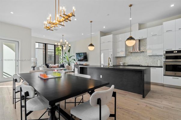Chandelier, Dining room, Interior, Kitchen, Pendant Lights, Recessed Lighting, Stainless Steel Appliances, Wood Texture Flooring
