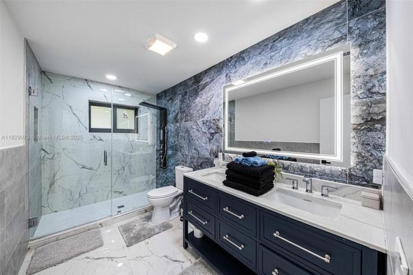 Bathroom, Dual Sink Vanities, Glass Shower, Interior, Marble, Marble Walls, Recessed Lighting