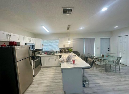 Dining room, Interior, Kitchen, Pendant Lights, Recessed Lighting, Stainless Steel Appliances, Wood Texture Flooring