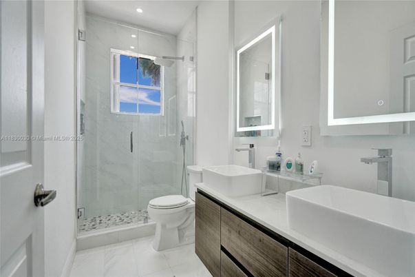 Bathroom, Dual Sink Vanities, Glass Shower, Interior, Marble, Marble Walls, Recessed Lighting