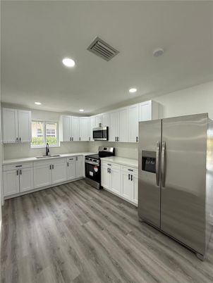 Interior, Kitchen, Recessed Lighting, Stainless Steel Appliances, Wood Texture Flooring