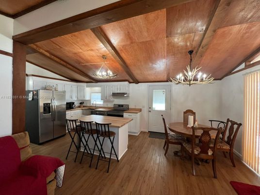 Chandelier, Dining room, Interior, Kitchen, Pendant Lights, Stainless Steel Appliances, Wooden Beams, Wooden Ceilings, Wood Texture Flooring