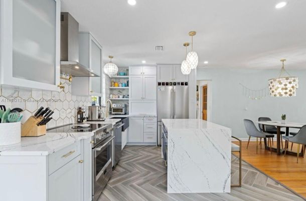 Dining room, Interior, Kitchen, Pendant Lights, Recessed Lighting, Stainless Steel Appliances, Wood Texture Flooring