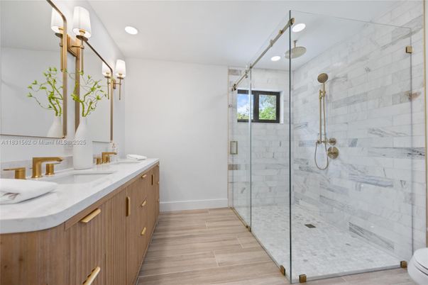 Bathroom, Dual Sink Vanities, Glass Shower, Interior, Marble Walls, Recessed Lighting, Wood Texture Flooring