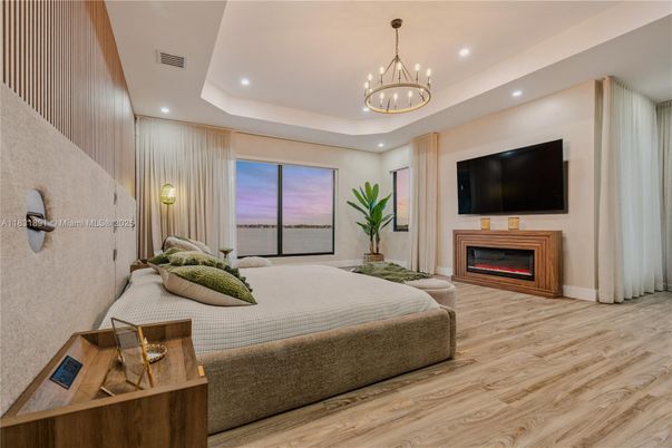 Bedroom, Chandelier, Fireplace, Interior, Recessed Lighting, Wood Texture Flooring