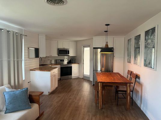 Dining room, Interior, Kitchen, Pendant Lights, Recessed Lighting, Stainless Steel Appliances, Wood Texture Flooring