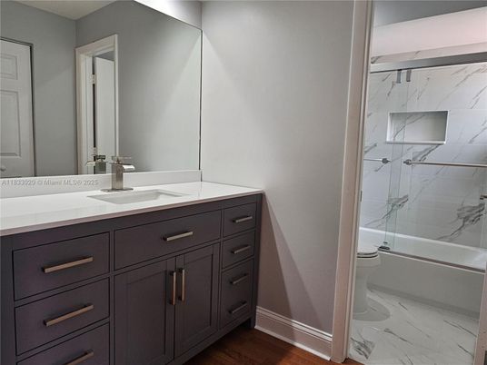 Bathroom, Dual Sink Vanities, Glass Shower, Interior, Marble, Marble Walls, Wood Texture Flooring