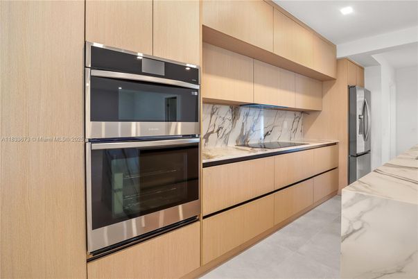 Interior, Kitchen, Marble Walls, Recessed Lighting, Stainless Steel Appliances