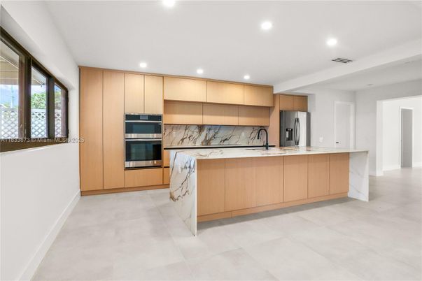 Interior, Kitchen, Marble Walls, Recessed Lighting, Stainless Steel Appliances