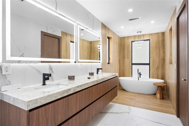 Bathroom, Dual Sink Vanities, Free Standing Baths, Interior, Marble, Marble Walls, Recessed Lighting, Wood Texture Flooring, Wooden Walls