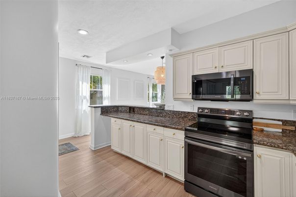 Chandelier, Interior, Kitchen, Recessed Lighting, Stainless Steel Appliances, Wood Texture Flooring